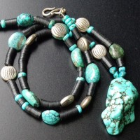 The Pendant is a large Turquoise colored Amazonite; smaller Turquoise Beads; silver plated Beads from Greece and black Bakelite Discs, Trade Beads, originally from Europe, now from Ghana length: 63 cm + 5 cm, weight: 79 g, prize: € 98.-