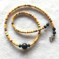 Onyx and Lava Beads surrounded by tiny Bakalite Heishis, yellow, orange and black, from Ghanalength: 48 cm weight: 12 gr price:€ 70.-